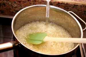 Pot of boiling candy mixture with thermometer
